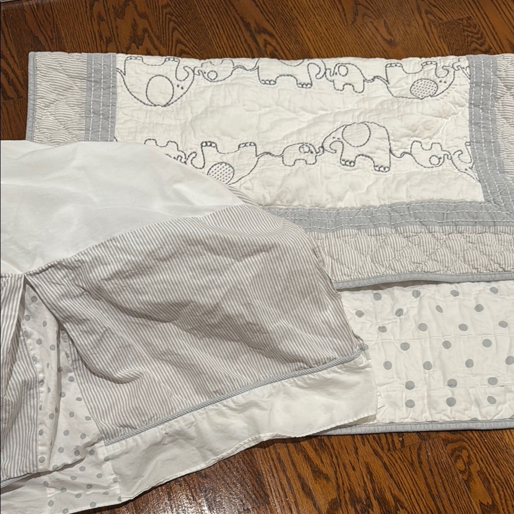Gray and White Quilted Bedding with Decorative Patterns
